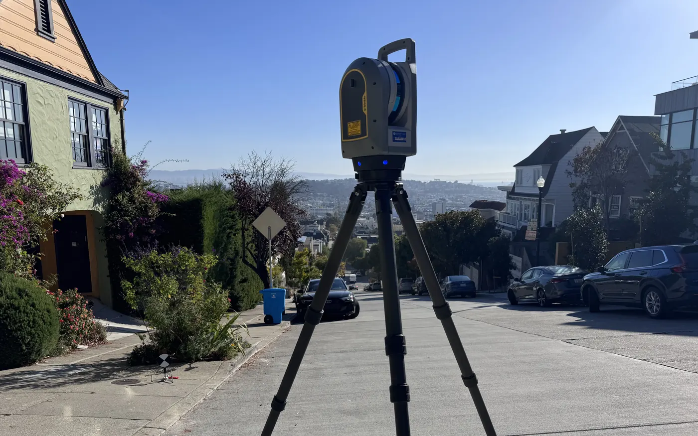 Contour Survey Trimble X9 laser scanner set up on a steep San Francisco residential street, with a checkerboard scan target on the sidewalk